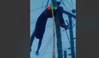 The electrocuted man hanging from the electric pole