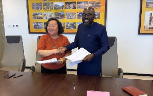 Michael Aidoo (R) after signing the agreement