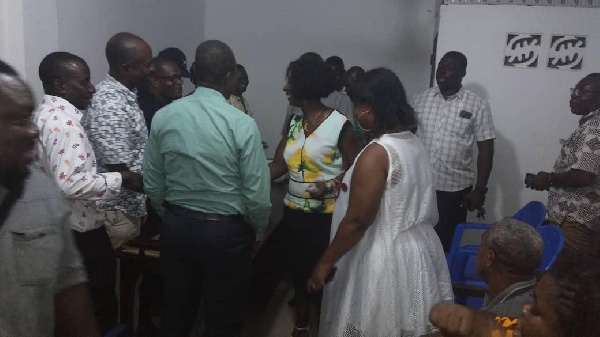 Sherry Ayittey (middle) intercating with some party members after a meeting