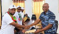 Bright Ege (L) is handing over his forms to the NDC Volta Regional Director of Elections, Dr Francis
