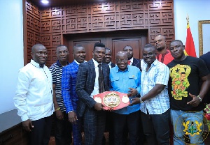 Commey presenting the title to President Akufo-Addo