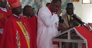 Napo shedding tears as Very Rev. Prof. Yinkah Sarfo tries to console him during the church service