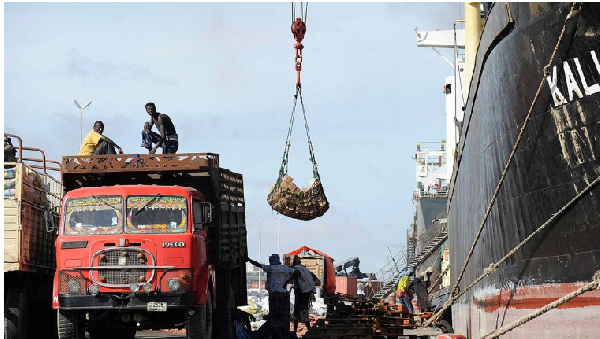 Porters offload goods in the sea port of Mogadishu, Somalia