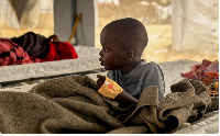A child infected with cholera receives treatment in the cholera isolation centre in a refugee camp