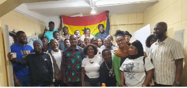 Ambassador Namoale in African print, pose for a photo with Ghanaians in Sao Paulo