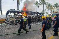 Firefighters work to off fire wey dey burn one bus for Puerto Vallarta, Mexico
