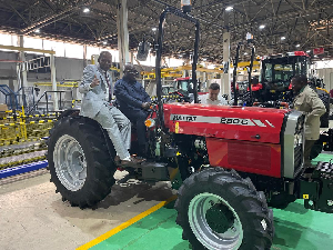 Minister of Food and Agriculture, Eric Opoku (behind steer) at the tractor plant in Turkey