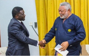 Bishop Charles Agyinasare (L) in a handshake with the late former president Jerry John Rawlings (R)