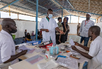 A Doctors without Borders (MSF) nurse treats a young Sudanese refugee in a camp in Chad