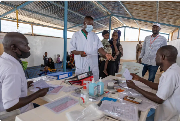 A Doctors without Borders (MSF) nurse treats a young Sudanese refugee in a camp in Chad