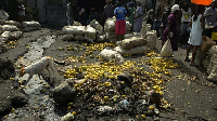 People buy food beside unsanitary waste in Port-au-Prince, Haiti
