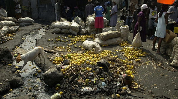 People buy food beside unsanitary waste in Port-au-Prince, Haiti