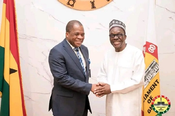 Rev. Wengam in a hand shake with the Speaker of Parliament, Alban Bagbin