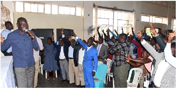 Dr Kizza Besigye supporters wave the V-sign during the consultative meeting