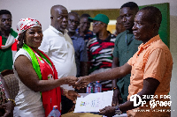 Prof. Dr. Grace Ayensu Danquah presenting her forms to an official of the EC