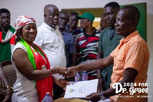 Prof. Dr. Grace Ayensu Danquah presenting her forms to an official of the EC