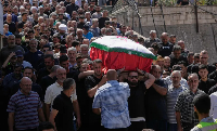 Mourners carry the coffin of Saja Sharara, who was killed in an Israeli air strike