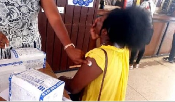 A young woman getting vaccinated