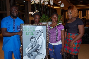 The porters presenting an appreciation artwork to Mr and Mrs Jibril for their support