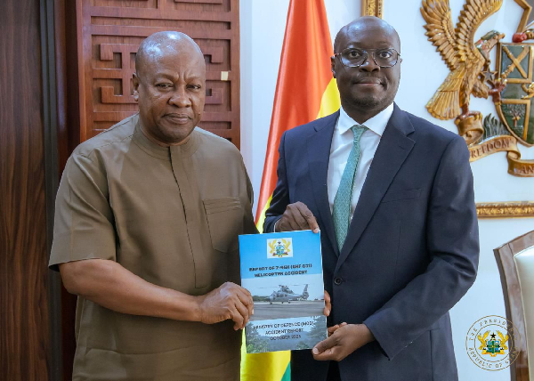Dr Ato Forson presenting the report to President Mahama