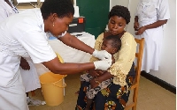 File Photo: A nurse administers a vaccine to a child