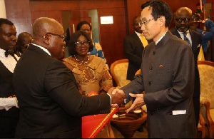 President Akufo-Addo exchanging pleasantries with one of the new envoy
