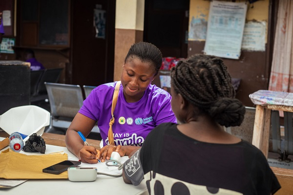 One of the workers from Mental Health Authority checking the vitals of a woman