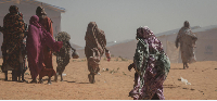 Sudanese refugee women walk through Tulum refugee camp in eastern Chad’s Wadi Fira province