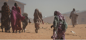 Sudanese refugee women walk through Tulum refugee camp in eastern Chad’s Wadi Fira province