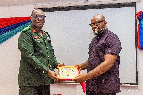 CEO of McDan Group of Companies, Daniel McKorley receiving a certificate from a military officer