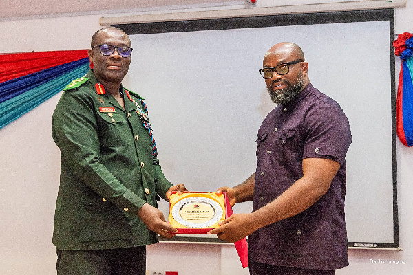 CEO of McDan Group of Companies, Daniel McKorley receiving a certificate from a military officer