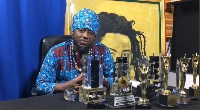 Blakk Rasta sits with all the awards he has won over the years