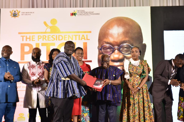 Richard Abbey presenting a copy to President Akufo-Addo