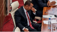 Prime Minister Abiy Ahmed reacts during a session in Parliament in the city of Addis Ababa