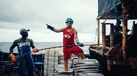 File photo of a Chinese and local crew member on a fishing boat