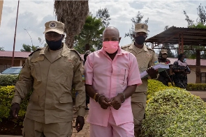Paul Rusesabagina wears a pink inmate's uniform as he is taken to court in 2020 in Kigali
