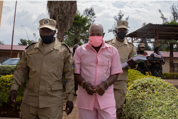 Paul Rusesabagina wears a pink inmate's uniform as he is taken to court in 2020 in Kigali