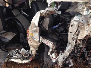 A mini bus rammed into a container that had fallen off a truck