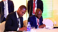 Daniel Ogbarmey Tetteh and Evans Osano signing the partnership