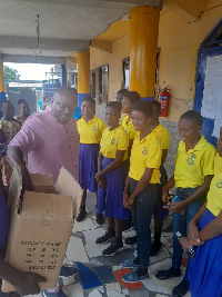 Reverend Kweku Addo presenting the items to the BECE candiates