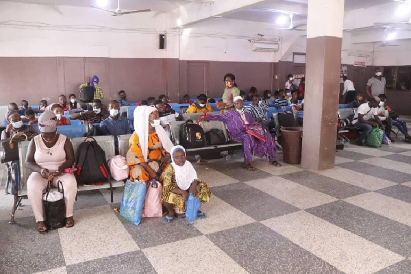 Some travelers waiting to board their bus at a bus terminal