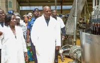 President Mahama with other in a factory(file photo)