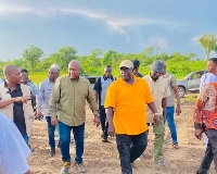 Former President, John Dramani Mahama with the people visiting the land
