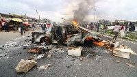 The shell of a police vehicle burnt by protesters along Mombasa Road in Mlolongo, Kenya