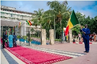 A man holds a Senegalese flag outside the National Assembly in Dakar