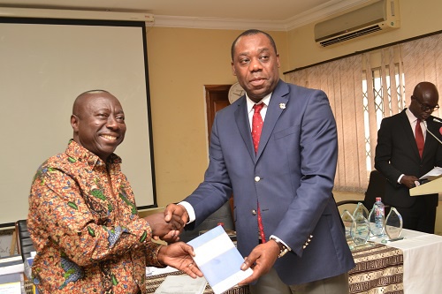 Director General, Kwame Owusu presenting mathematics textbooks to  the Education Minister