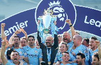 Pep Guardiola and his Manchester City coaching staff lifting the Premier League title