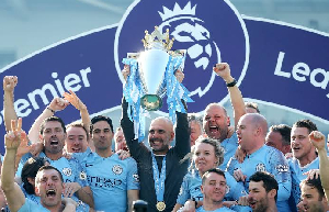 Pep Guardiola and his Manchester City coaching staff lifting the Premier League title