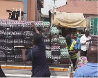 Some officials offloading the items from a truck