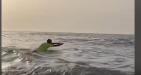 The man swimming to rescue the drowning individual from the sea